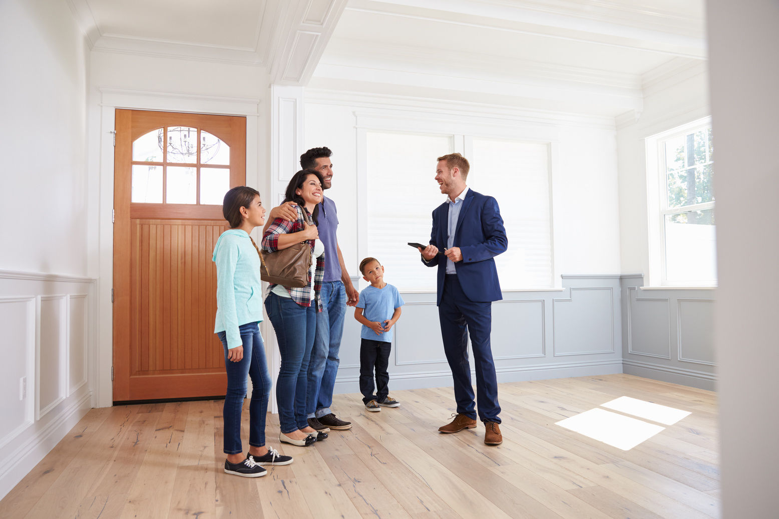 Realtor Showing Hispanic Family around New Home